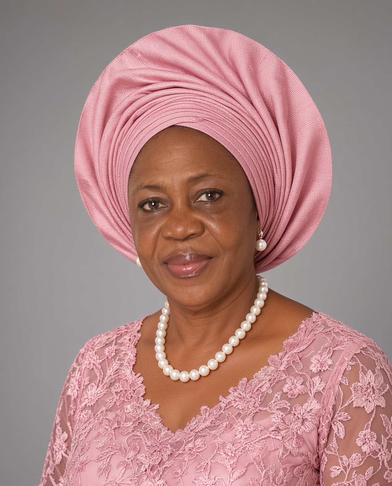 Victoria Adieme Ogbulie wearing a pink gele and pearl necklace